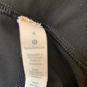 Black Lululemon leggings with mesh detail on leg - size 4
